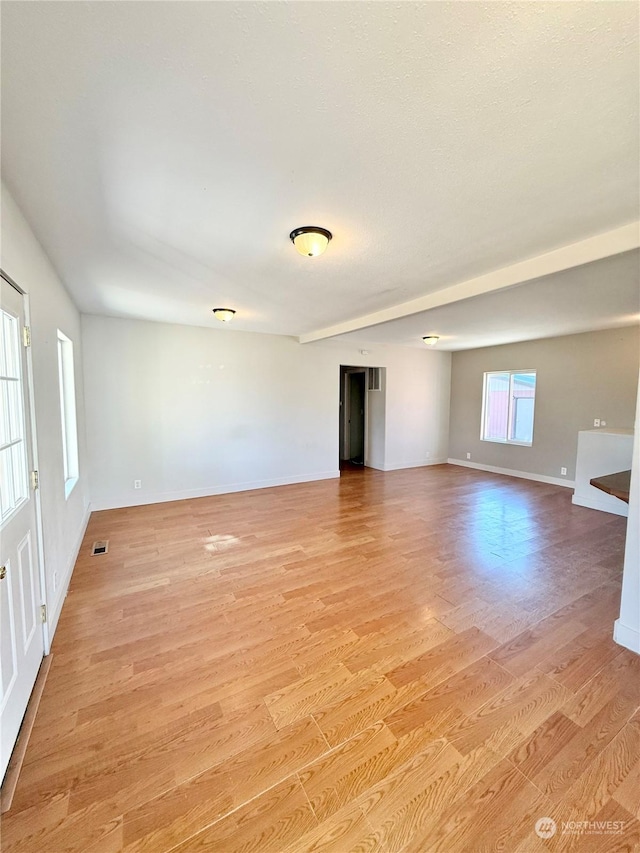 spare room with light hardwood / wood-style flooring