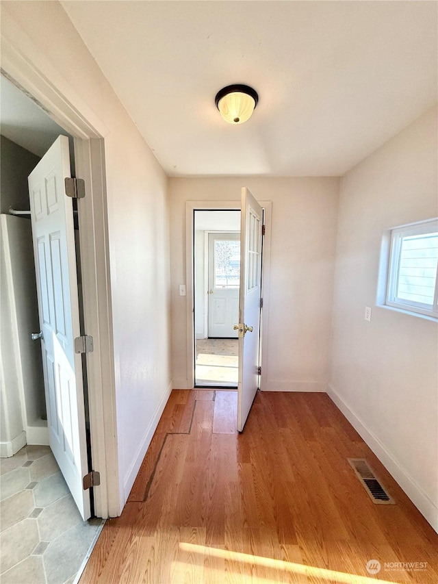 doorway with light wood-type flooring