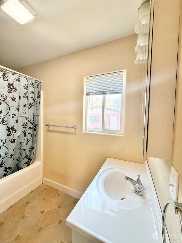 bathroom with shower / tub combo with curtain, vanity, and tile patterned flooring