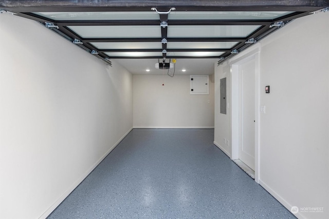 garage with a garage door opener and electric panel