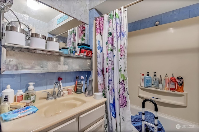 bathroom with shower / bath combo with shower curtain, vanity, and decorative backsplash