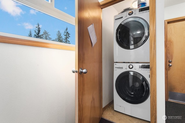 laundry room featuring stacked washer / drying machine