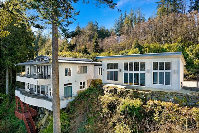 rear view of house with a balcony