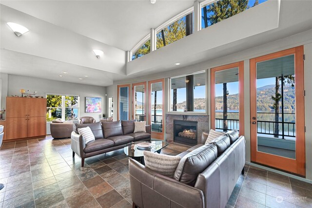 living room featuring plenty of natural light, a mountain view, and a towering ceiling