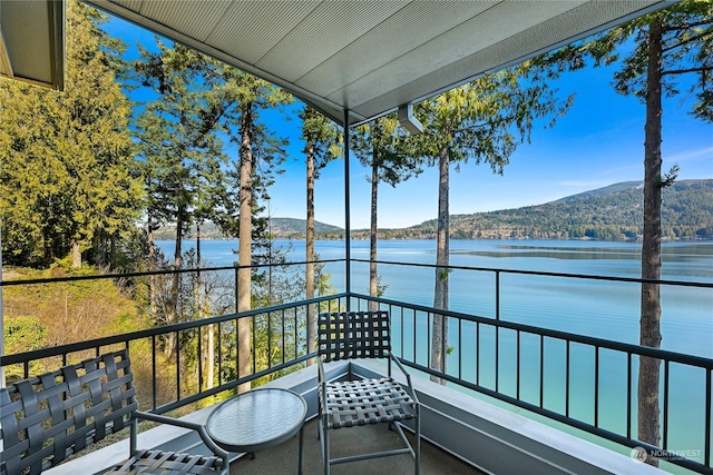 balcony with a water and mountain view