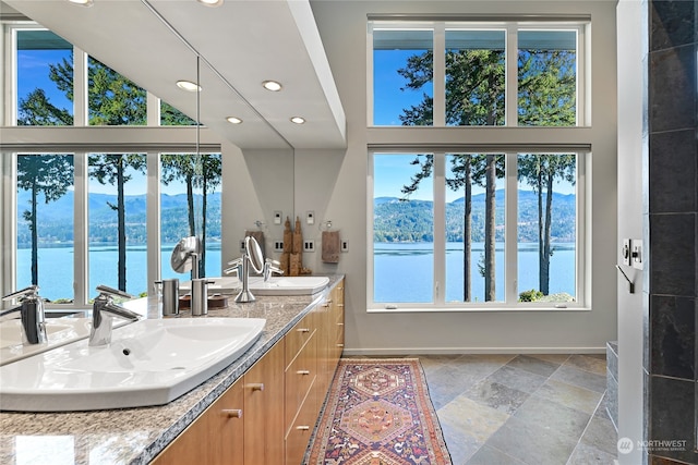 bathroom featuring a water and mountain view and vanity