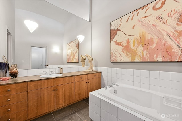 bathroom featuring vanity, tile patterned floors, and tiled bath