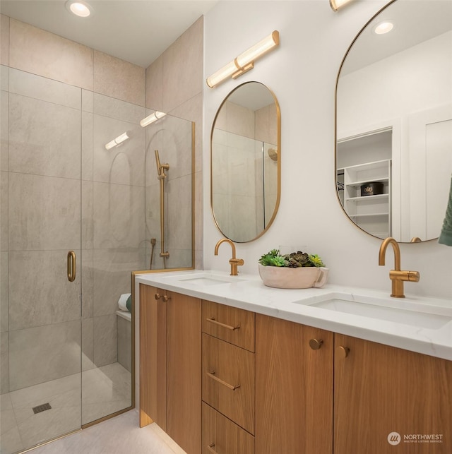 bathroom featuring vanity and a shower with door