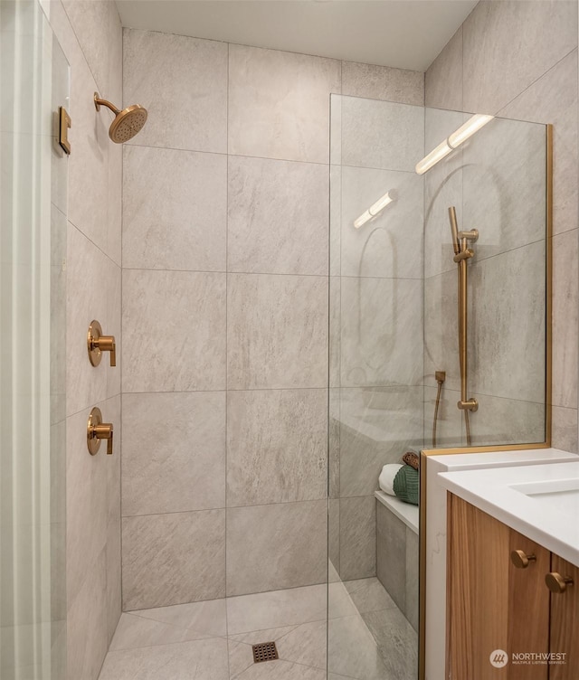 bathroom featuring vanity and a tile shower