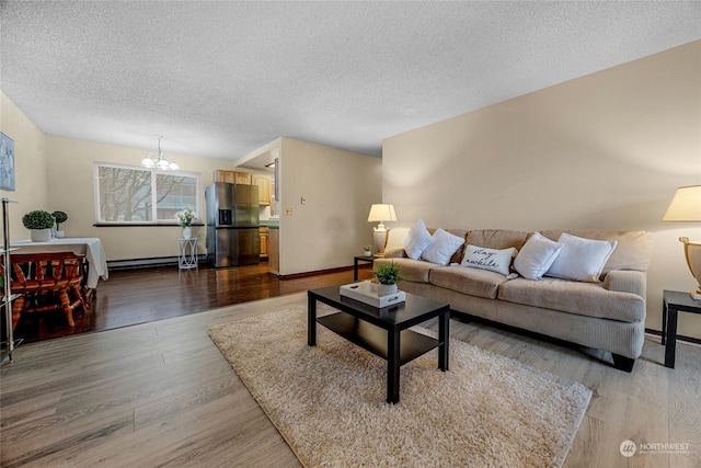 living room with hardwood / wood-style flooring, a textured ceiling, and a notable chandelier