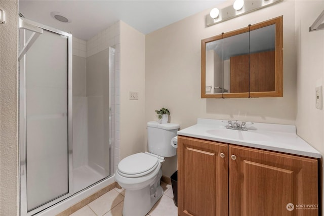 bathroom with an enclosed shower, vanity, tile patterned floors, and toilet