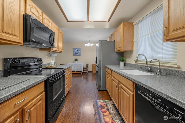 kitchen with a notable chandelier, dark hardwood / wood-style floors, sink, and black appliances