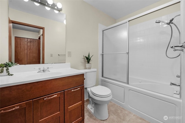 full bathroom with vanity, tile patterned floors, shower / bath combination with glass door, and toilet