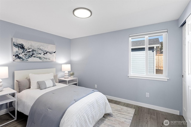 bedroom with dark hardwood / wood-style flooring