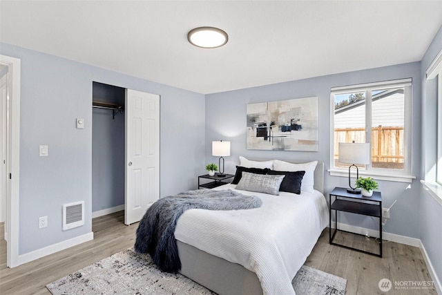 bedroom featuring light hardwood / wood-style floors and a closet