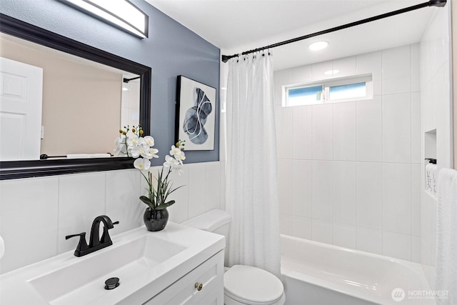 full bathroom featuring vanity, shower / bathtub combination with curtain, and toilet