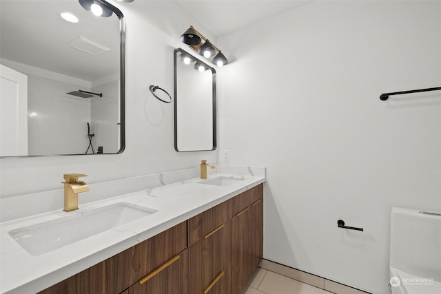 bathroom featuring tile patterned floors, toilet, and vanity