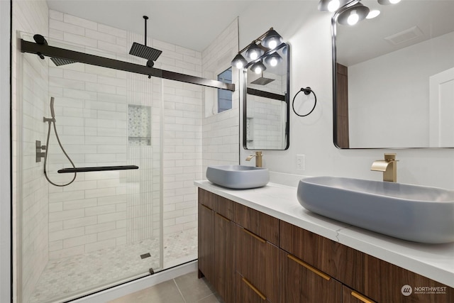 bathroom featuring tile patterned flooring, vanity, and walk in shower