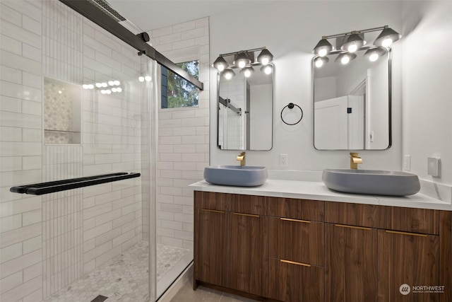 bathroom with vanity and a shower with door