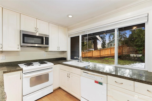 kitchen featuring white appliances, light hardwood / wood-style floors, sink, and white cabinets