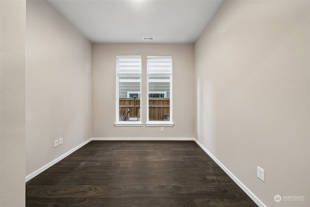 unfurnished room with dark hardwood / wood-style flooring