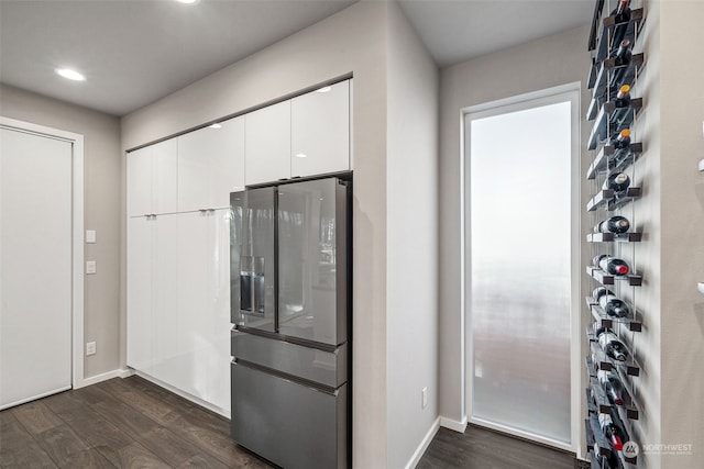 kitchen with white cabinetry, stainless steel fridge with ice dispenser, and dark hardwood / wood-style flooring