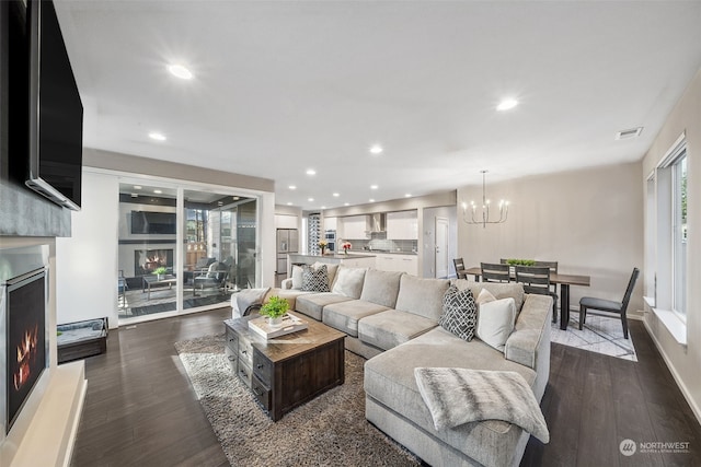 living room with an inviting chandelier and dark hardwood / wood-style floors