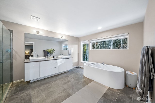 bathroom featuring vanity and shower with separate bathtub