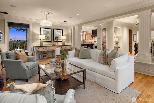 living room with light hardwood / wood-style flooring and ornate columns