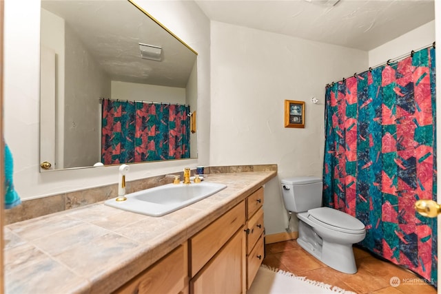 bathroom featuring tile patterned floors, vanity, and toilet