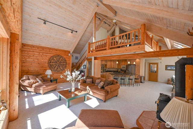 carpeted living room featuring wood ceiling, track lighting, beam ceiling, and high vaulted ceiling