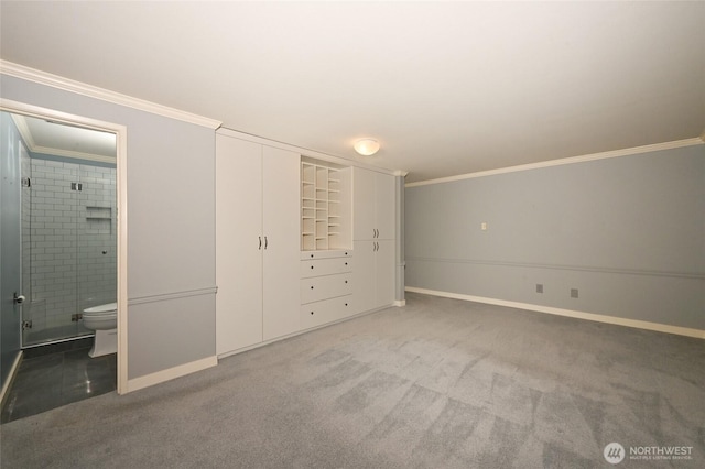 unfurnished bedroom with ornamental molding, carpet flooring, and ensuite bath