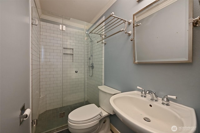 bathroom featuring ornamental molding, sink, an enclosed shower, and toilet