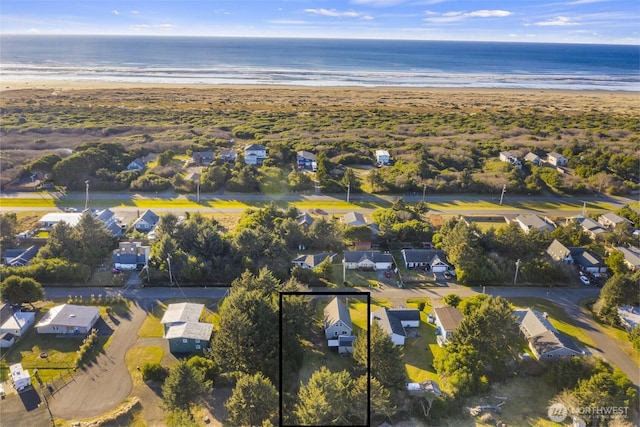 aerial view with a residential view, a water view, and a beach view