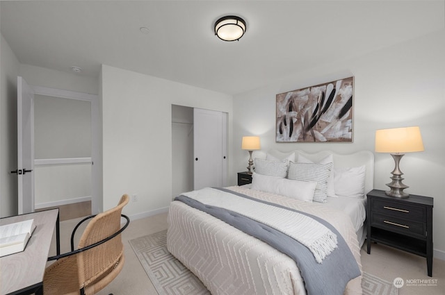 bedroom with light colored carpet and a closet