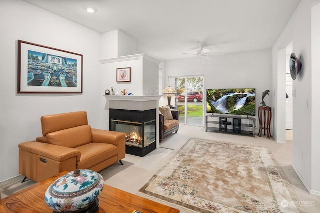 interior space with ceiling fan, a fireplace, and light carpet