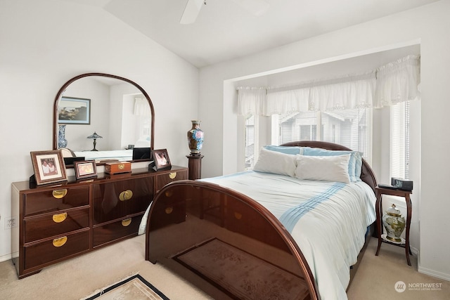 bedroom with light carpet, vaulted ceiling, and ceiling fan