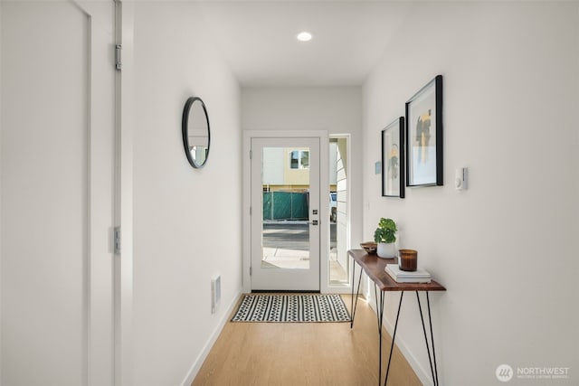 entryway featuring recessed lighting, wood finished floors, visible vents, and baseboards