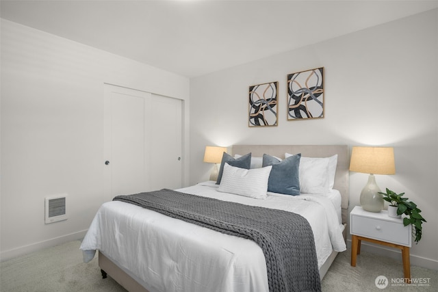 bedroom featuring carpet, baseboards, and a closet