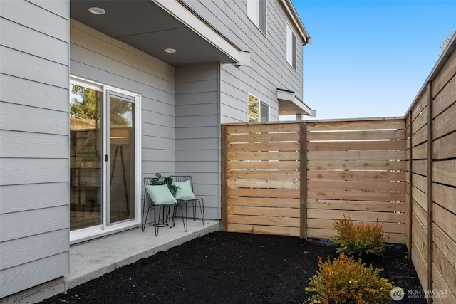 view of side of property featuring fence