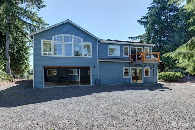 back of property featuring a balcony