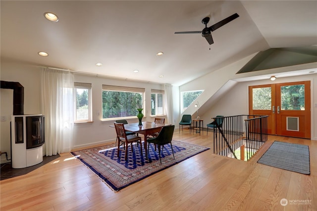 dining room featuring french doors, lofted ceiling, and light hardwood / wood-style floors