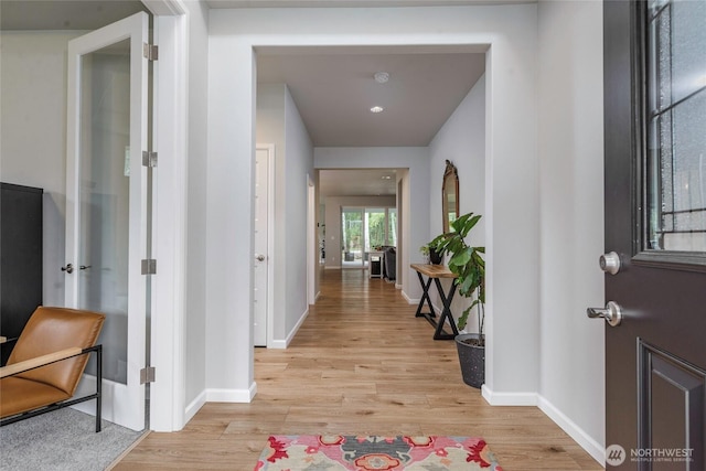 corridor featuring light hardwood / wood-style flooring