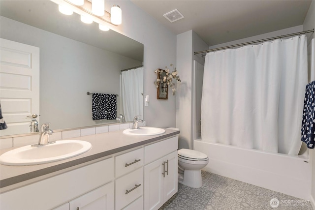 full bathroom featuring toilet, vanity, and shower / bathtub combination with curtain