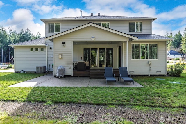 rear view of house featuring a yard, a patio, and central AC unit