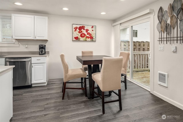 dining room featuring heating unit and dark hardwood / wood-style floors