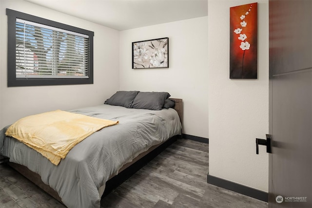 bedroom with hardwood / wood-style flooring