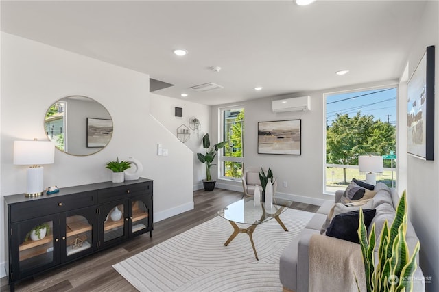 living room with an AC wall unit and dark hardwood / wood-style flooring