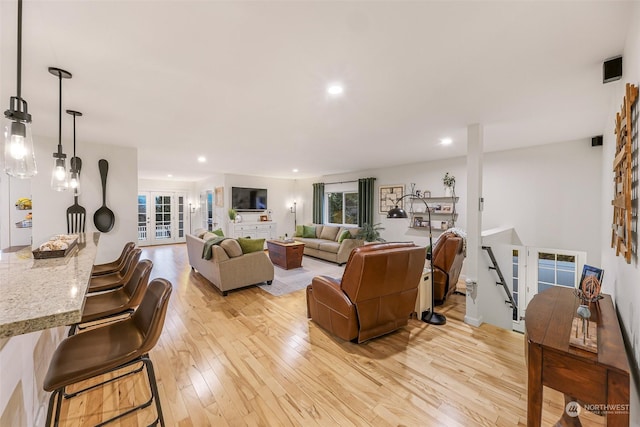 living room with light hardwood / wood-style flooring and french doors