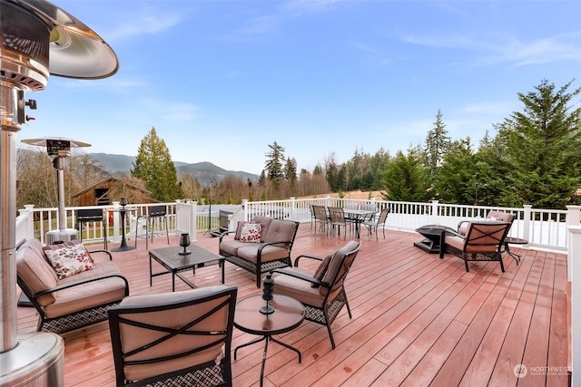 wooden deck with a mountain view and an outdoor hangout area